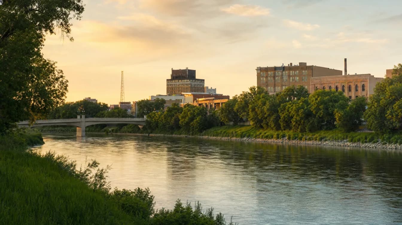 Assiniboine River flowing through Brandon, Manitoba — industrial wastewater treatment service area in Canada